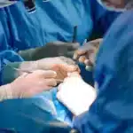 Surgeons performing breast fat fill surgery procedure